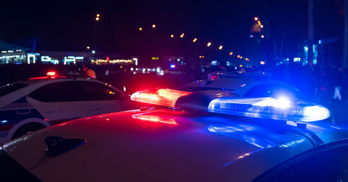 Police car sirens on a road at night.