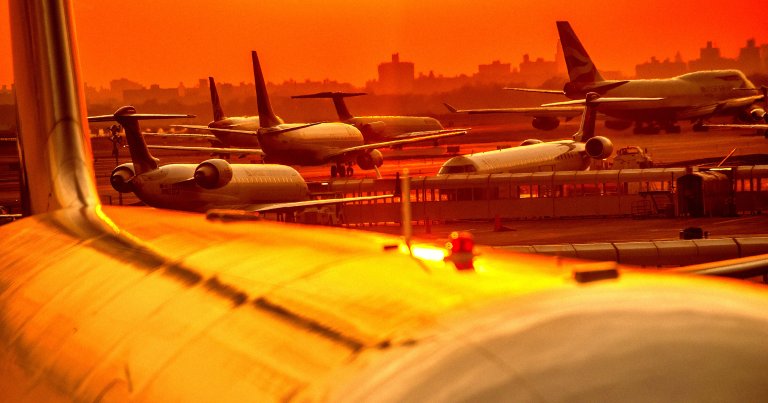 A photo of planes on the tarmac at an airport.