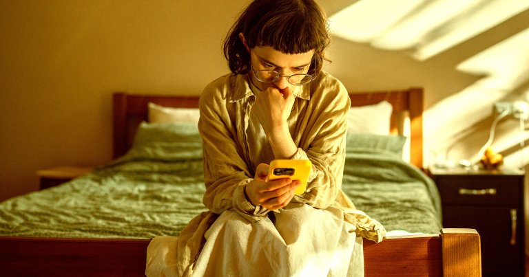 A color-treated photo of a teen using a smartphone.