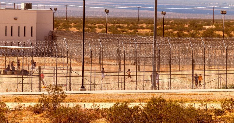 Prisoners are seen inside a prison exercise yard at the California City Immigration Processing Center, the state's newest and largest ICE prison.
