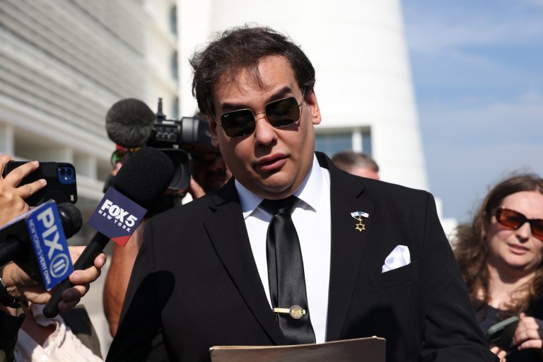 George Santos is shown wearing a suit, tie, and sunglasses.