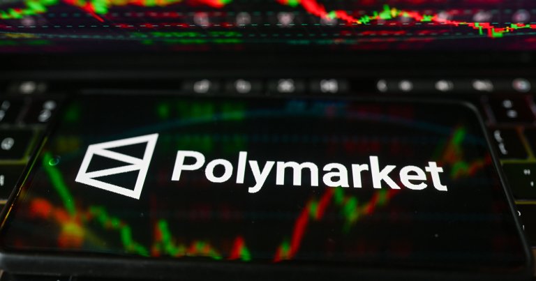 The Polymarket logo is displayed on a smartphone with stock market percentages in the background