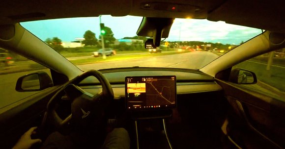 A screenshot of a video showing a Tesla self-driving using an open source AI system.