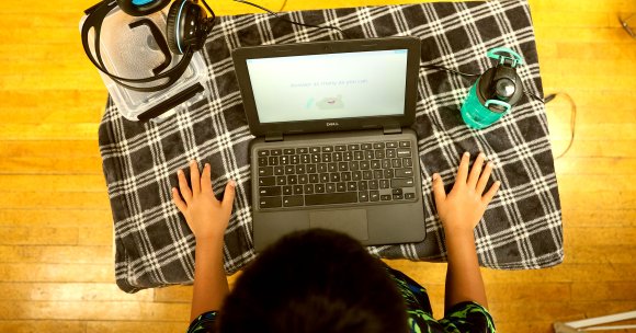 Lukkas Powao, 8, answers problem-solving questions on his computer.