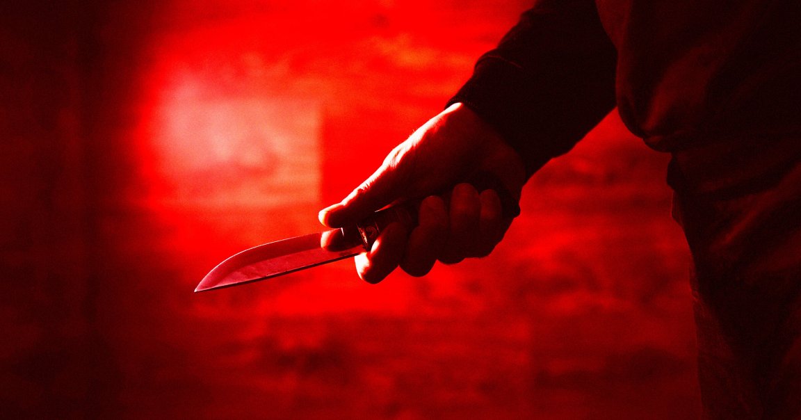 A color-treated photo of a man holding a knife.