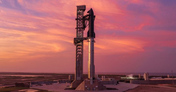 A SpaceX Starship and its booster on the launch pad.