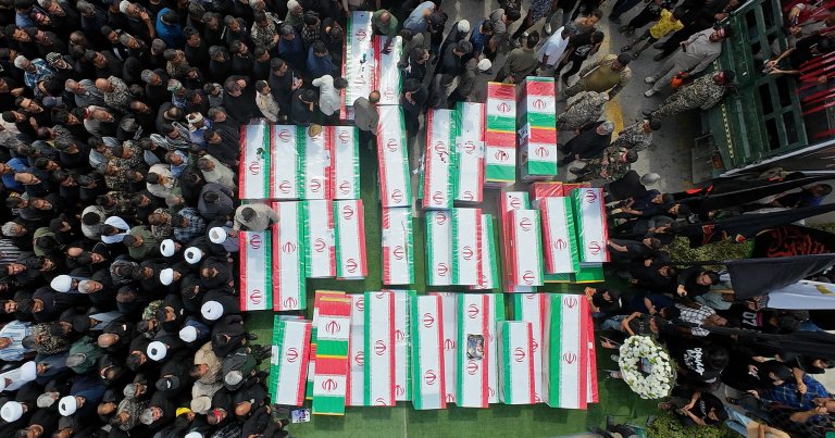 Coffins are assembled as funerals are held for Iranian students and staff from a girls' school.