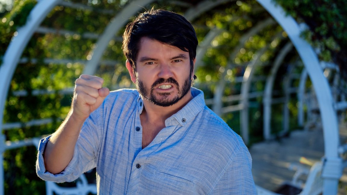 A stock photo shows an angry man shaking his fist.