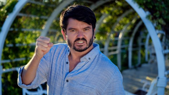 A stock photo shows an angry man shaking his fist.