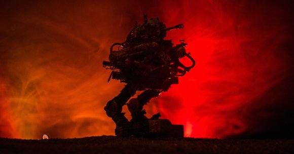 The silhouette of a robot with guns.
