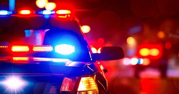 A police car with its lights turned on.