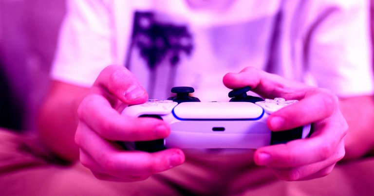 A person using a PlayStation 5 controller.