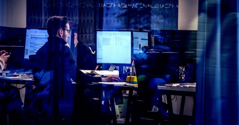 An office worker looking at a computer.