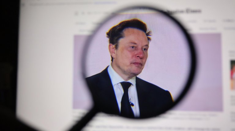An illustration shows a photo of Elon Musk under a magnifying glass.