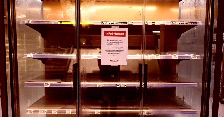 A customer notice displayed on empty fresh-food refrigerators at an Intermarche supermarket in Nevez, western France.