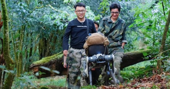 Scientific expedition team members work with DEEP Robotics’ LYNX M20S wheeled-legged robot in the Ailao Mountains.