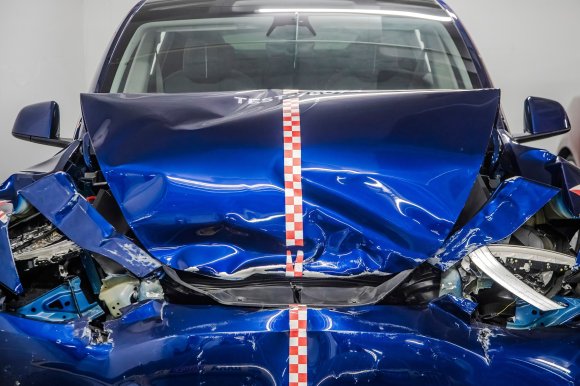 A photo shows a crashed Tesla.