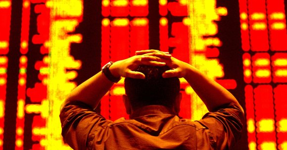 An investor reacts as he monitors the share index at a private stock market gallery.