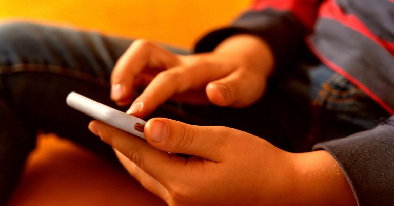 A young child using a smartphone.