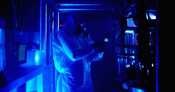 Lab technicians in a lab examining evidence.