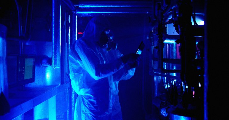 Lab technicians in a lab examining evidence.