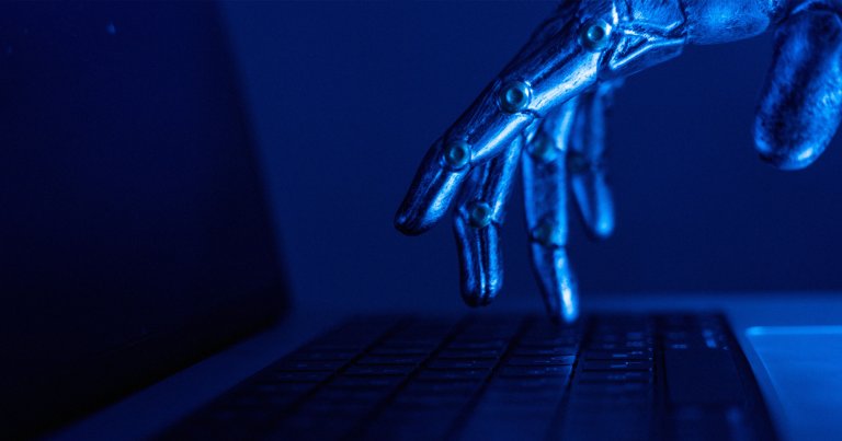 A robot finger hovering over a keyboard.