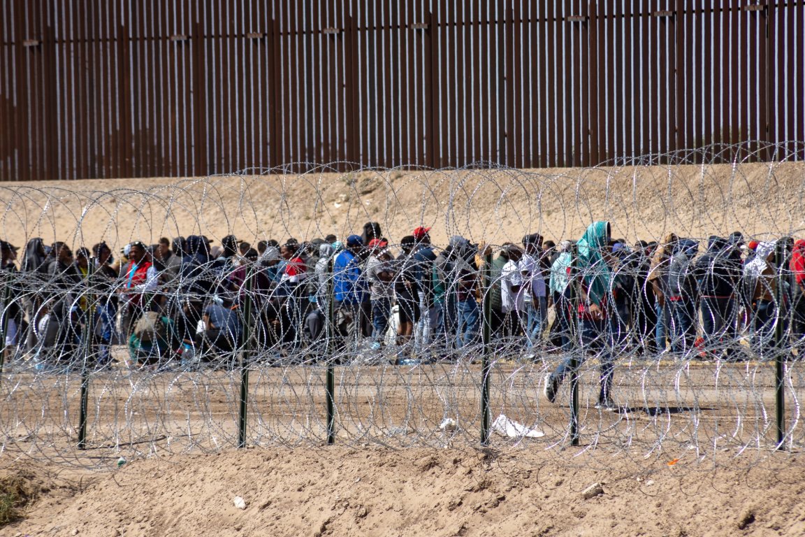 A photo shows immigrants seeking asylum at the United States' southern border.